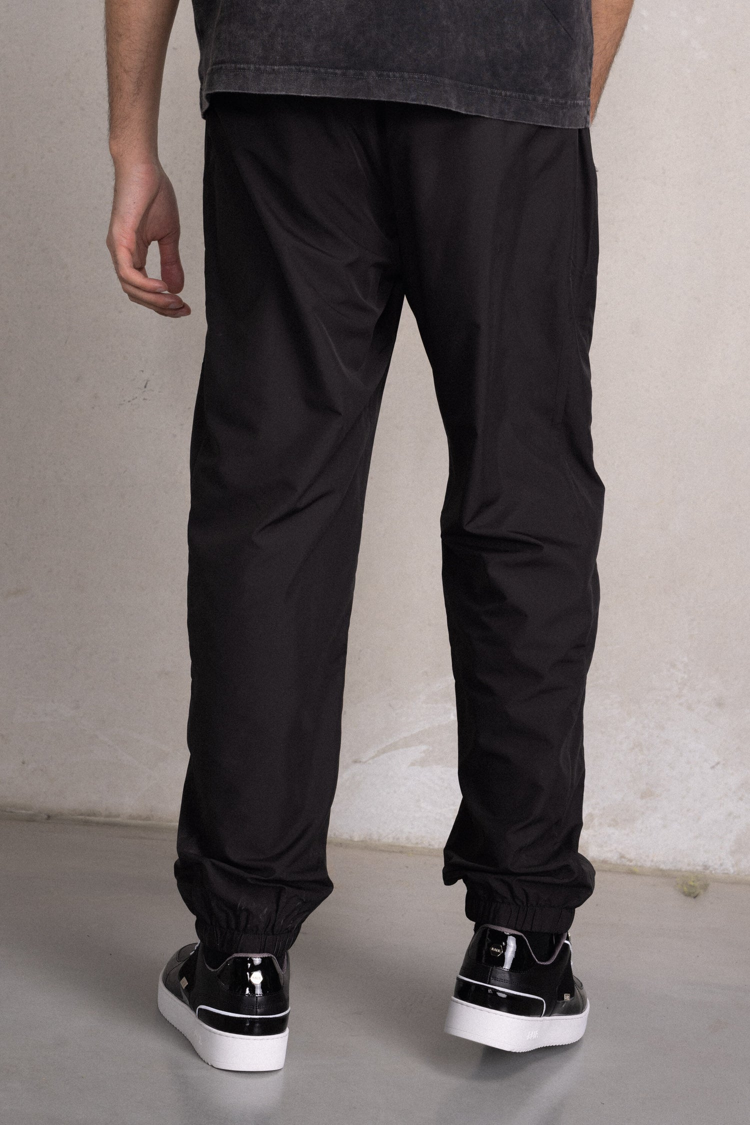 Fear of God Essentials Jet Black Relaxed Trousers | PacSun